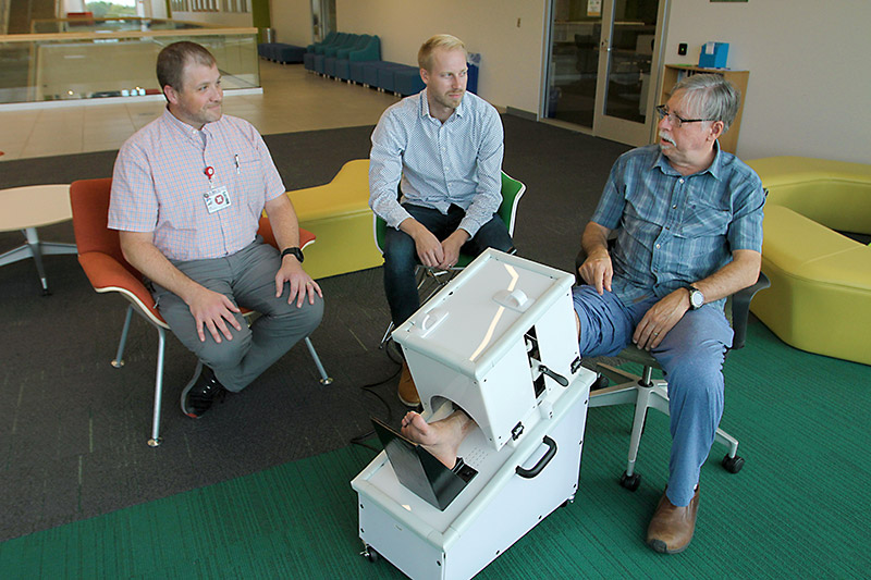 William Snodgrass, right, fractured his tibia in a plane crash. He was a participant in a research tibia fracture research study led by Nikiah Nudell, left, manager of the trauma research team at Medical Center of the Rockies, and Kevin Labus, research scientist with CSU and co-investigator in the study.