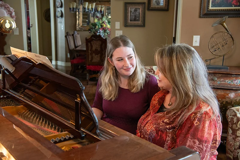 After learning that Aubriana suffered a stroke at birth, her mom enfolled Aubriana in a variety of therapies and activities, including piano lessons, to help her recover. She and her mother still enjoy playing together. Photo by Chuck Bigger, for UCHealth.